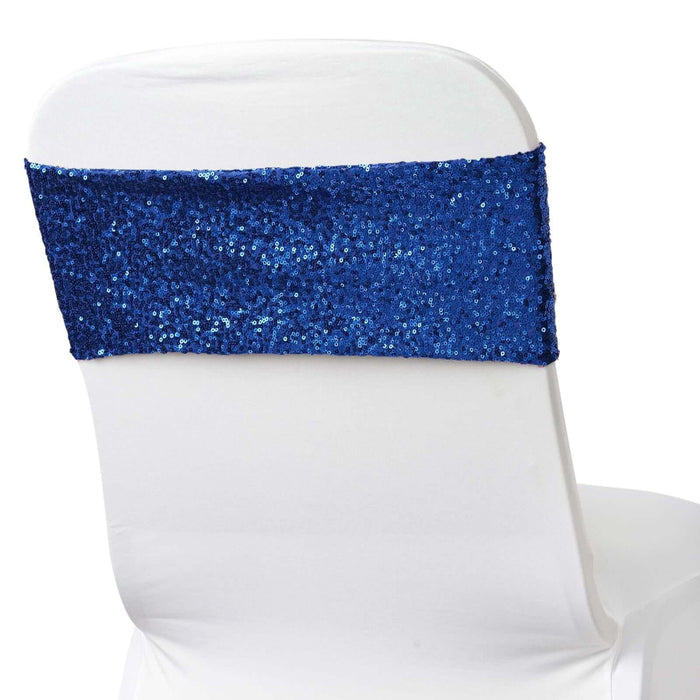 Blue sequined chair cover sash on a white chair.