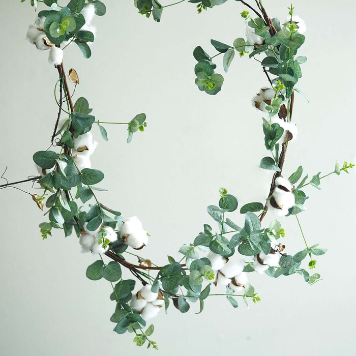 Cotton and eucalyptus wreath on a neutral background