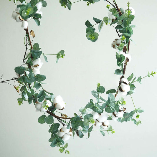 Cotton and eucalyptus wreath on a neutral background