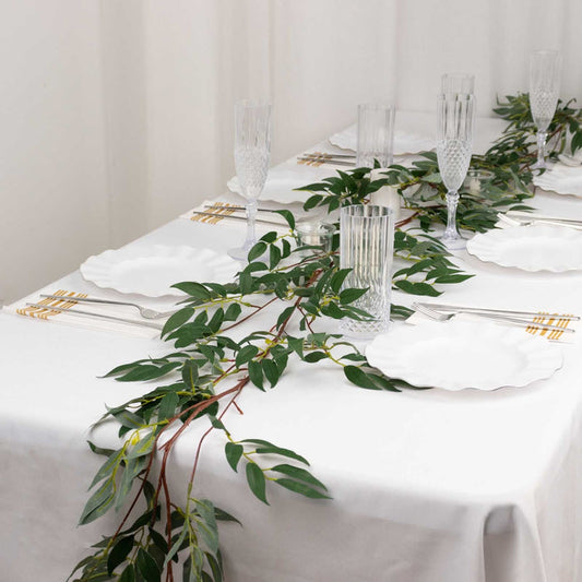 Elegant table setting with greenery and glassware for a sophisticated dining experience.