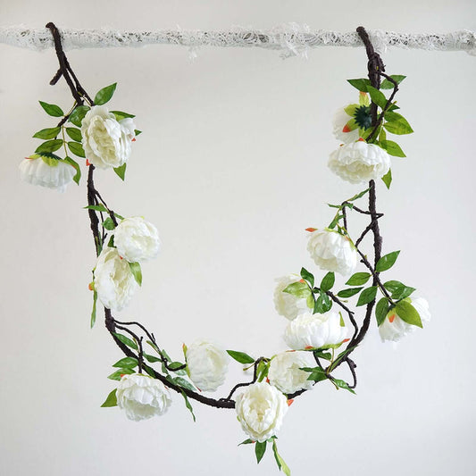 Artificial white flower garland on a branch
