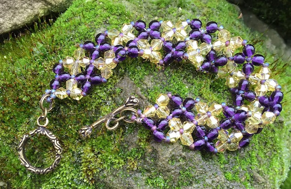 This Purple and Topaz Crystal and Czech glass Druk bracelet measures 6 1/2".