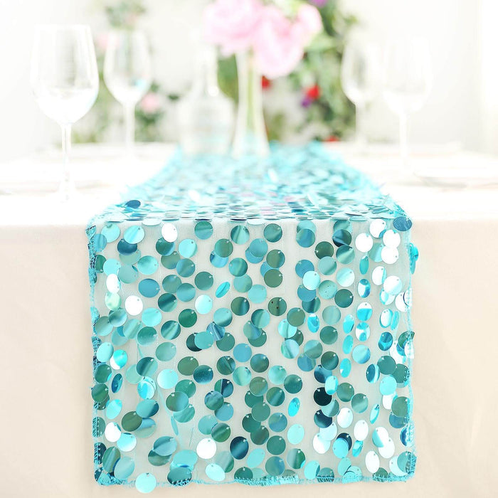 Turquoise sequin table runner on a dining table with floral decor.
