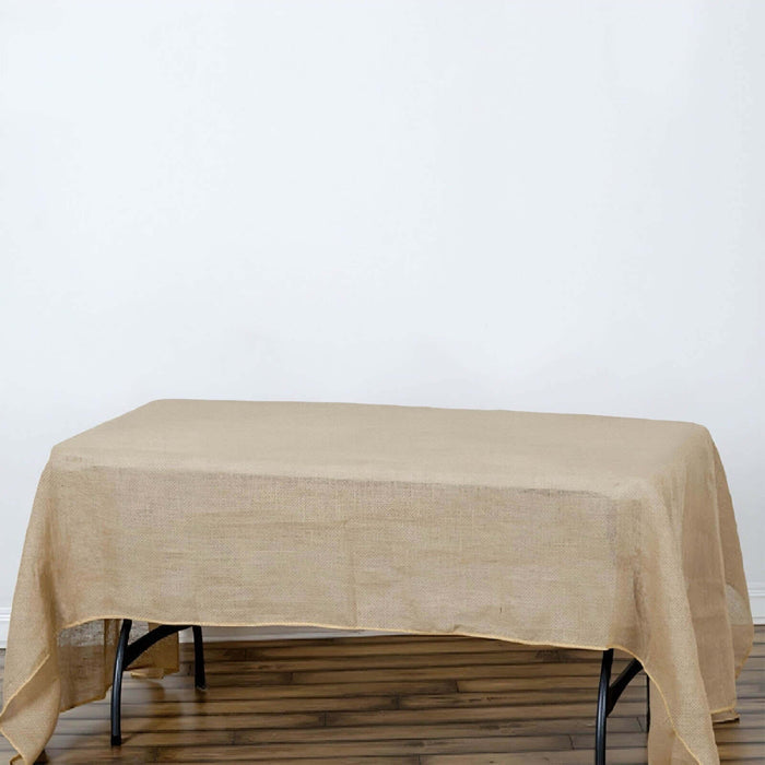 Linen tablecloth draped over a table on a plain background.