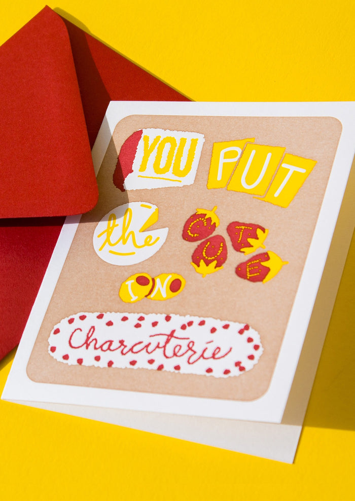 A greeting card with fruit and cheese spelling out "You put the cute in charcuterie".