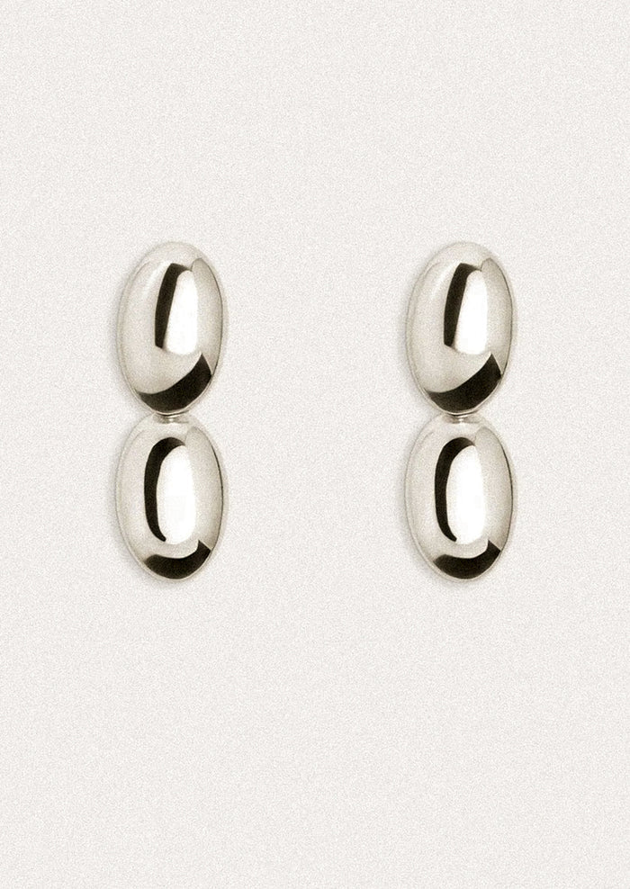 Pair of silver earrings on a white background