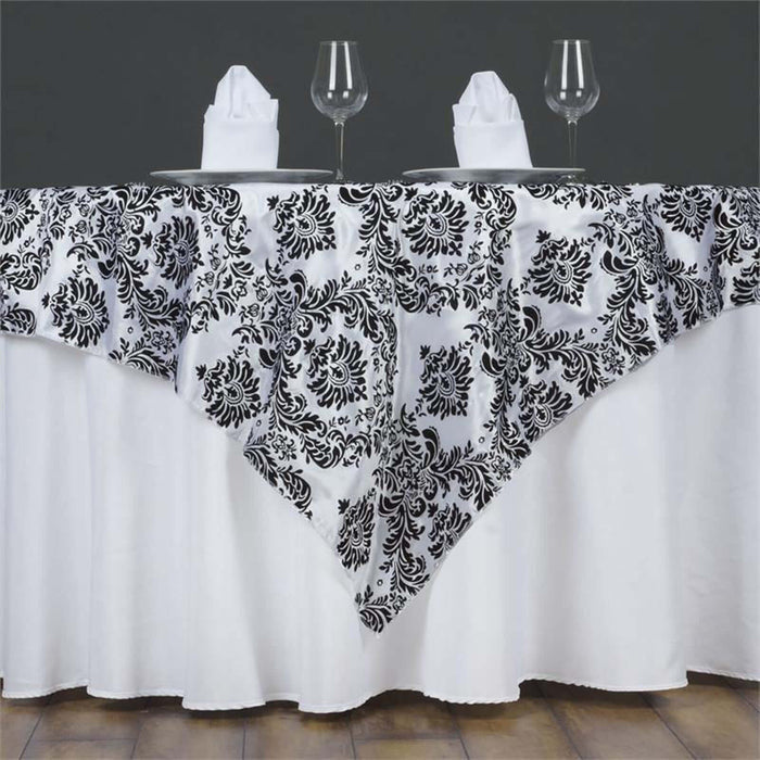 Elegant black and white tablecloth with floral design for formal dining settings.