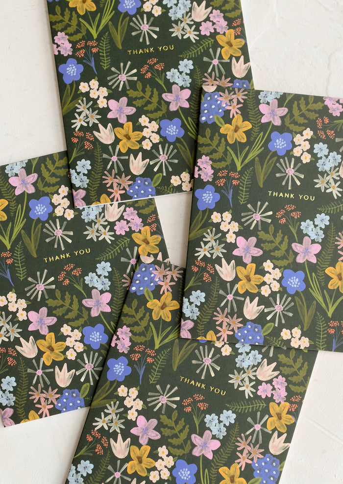 A set of thank you cards with floral print on olive green background.
