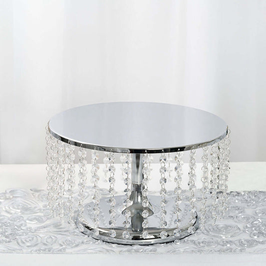 Round silver table with crystal accents on a reflective surface.