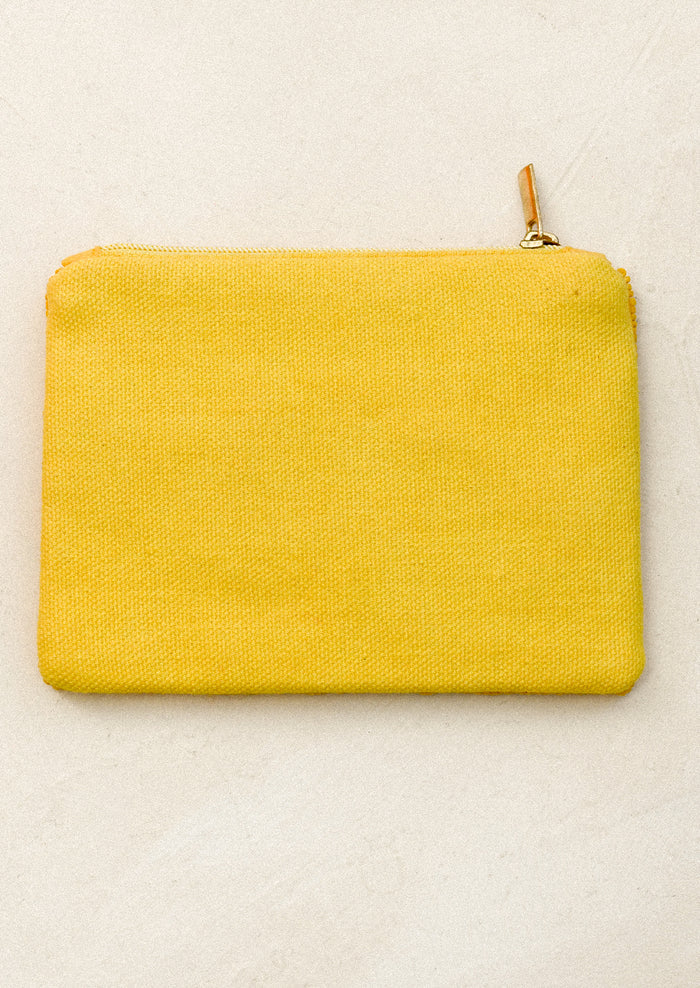 Beaded pouch with red tomato patterns on a yellow background.
