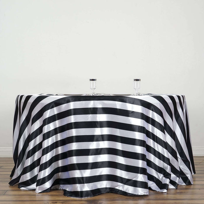 Black and white striped tablecloth draped over a round table