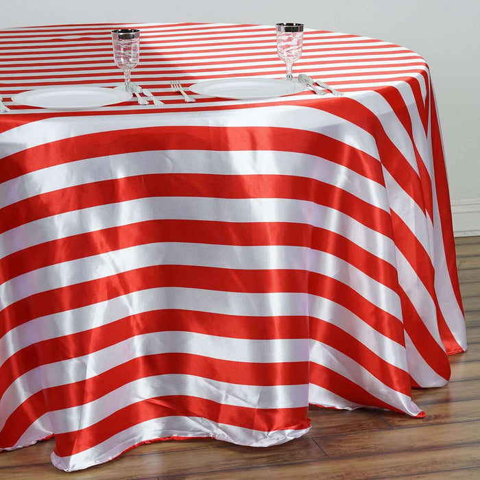 Red and white striped tablecloth draped over a round table.