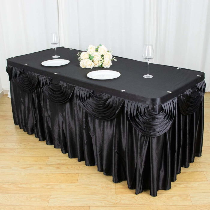 Black tablecloth with elegant draping for events and dining.