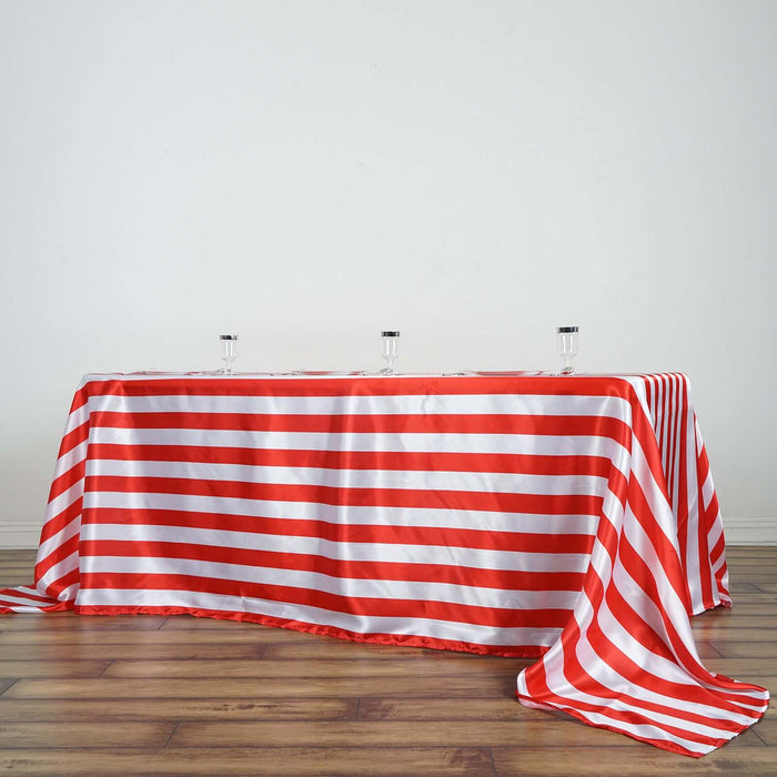 Red and white striped tablecloth draped over a table with glasses