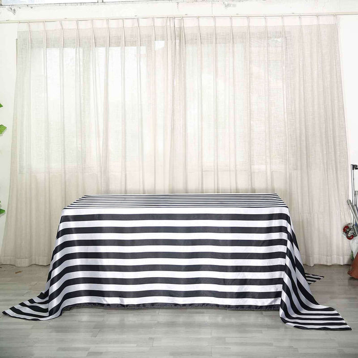 Striped tablecloth on a table in a softly lit room with sheer curtains.