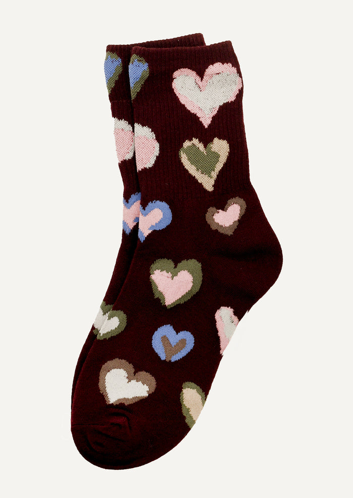 Brown sock with colorful heart patterns on a white background