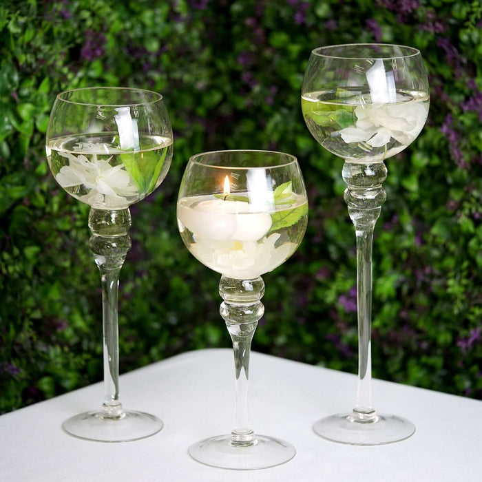 Elegant glassware with floral accents on a lush green backdrop.