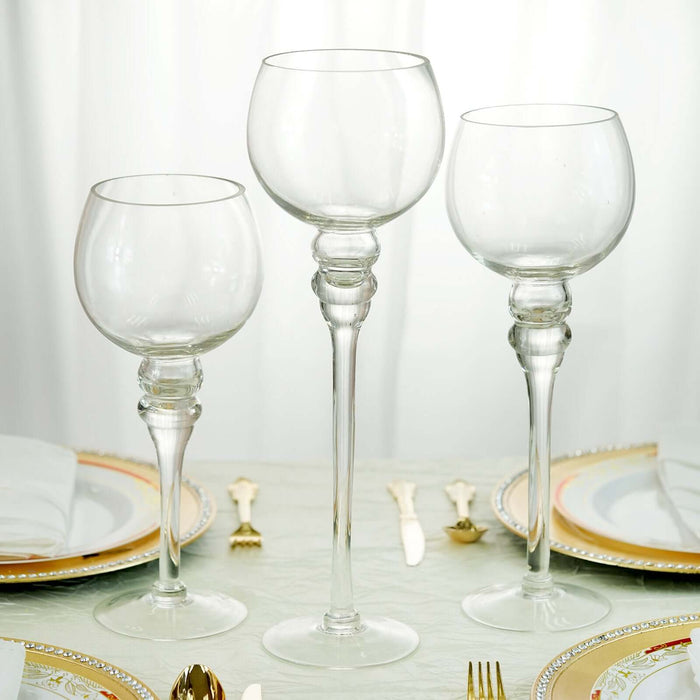 Elegant glass goblets in three sizes on a dining table setting.