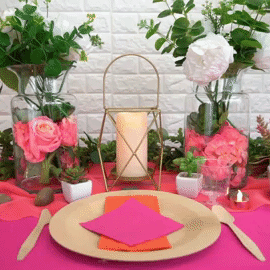 Colorful table setting with flowers and candle in an elegant arrangement.
