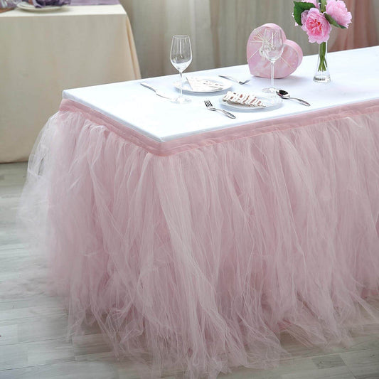 Pink tulle table skirt draped elegantly around a dining table setting.