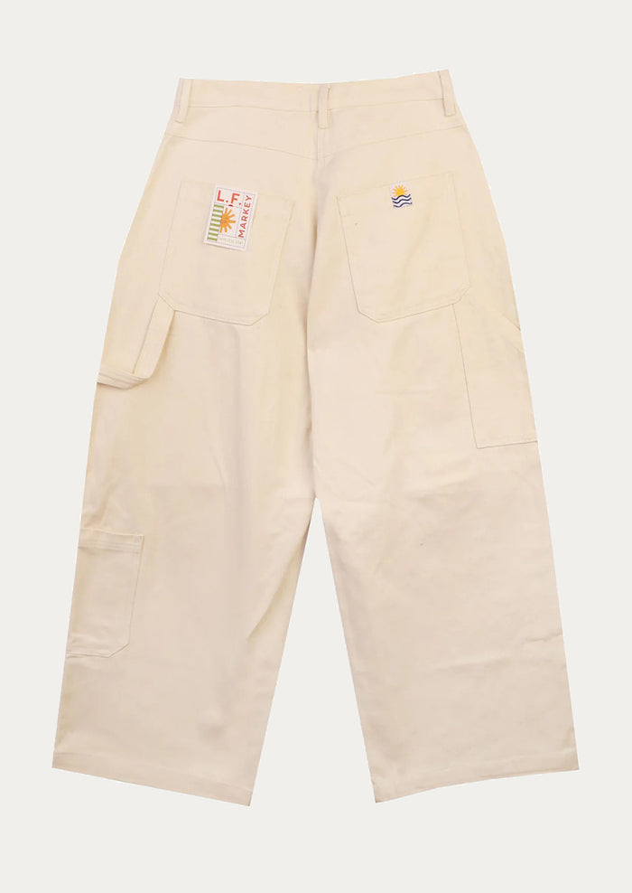 A pair of workwear-inspired pants in ecru color.