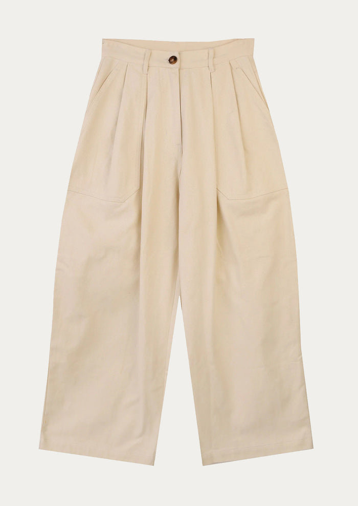 A pair of workwear-inspired pants in ecru color.
