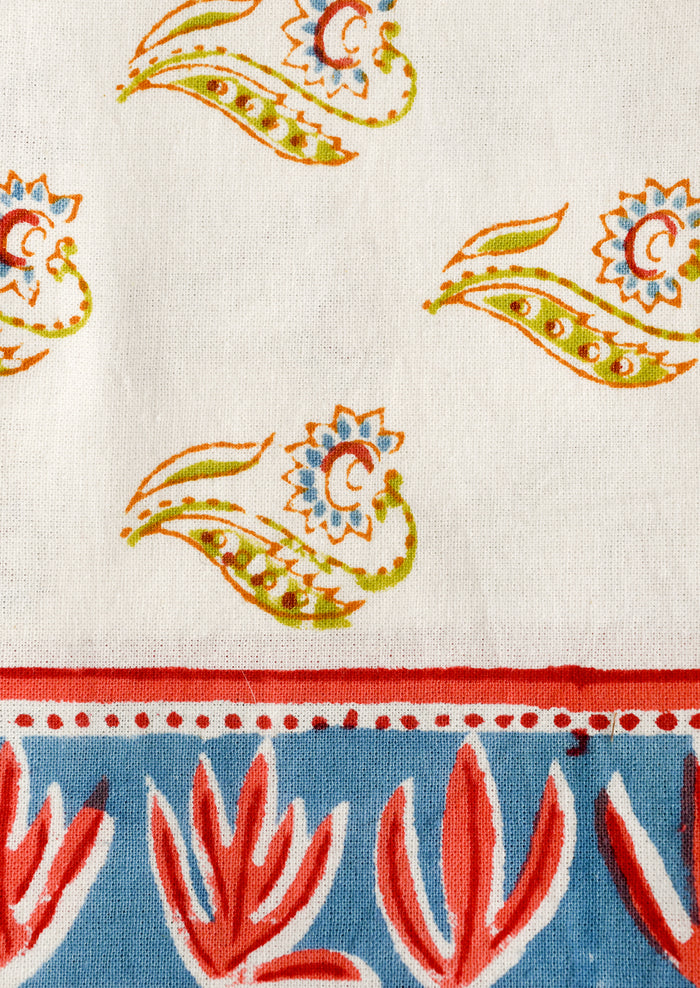 Close-up of fabric with colorful paisley patterns on a white background
